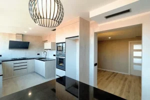 Cocina con marco de obra y separación visual en piso reformado de Barcelona